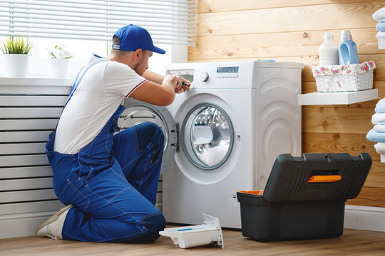 Professional appliance repair technician servicing washing machine in Arlington, Virginia